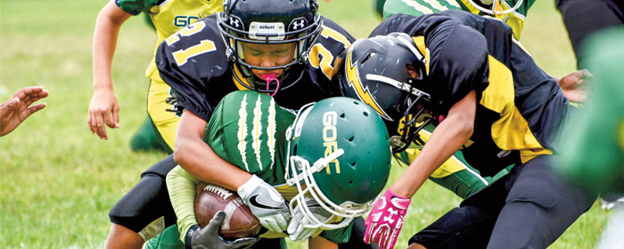 a football player being tackled by the other team