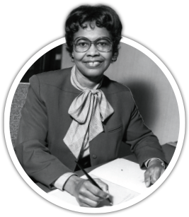 A black and white photo of a smiling woman writing in a book while posing for the picture