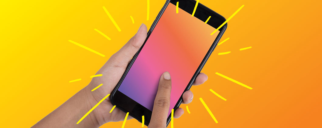 A hand holding a phone and pointing to the screen