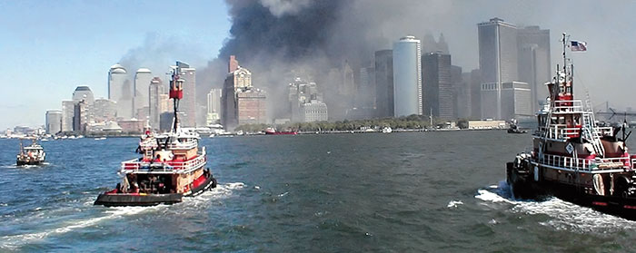 boats approaching Lower Manhattan while it&apos;s covered in smoke