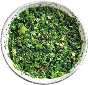 A bowl of green leafy seasoning