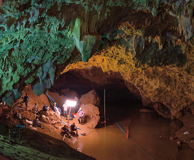 Enlargeable photo of rescuers within the cave accompanied with lamps and tools to look for the boys