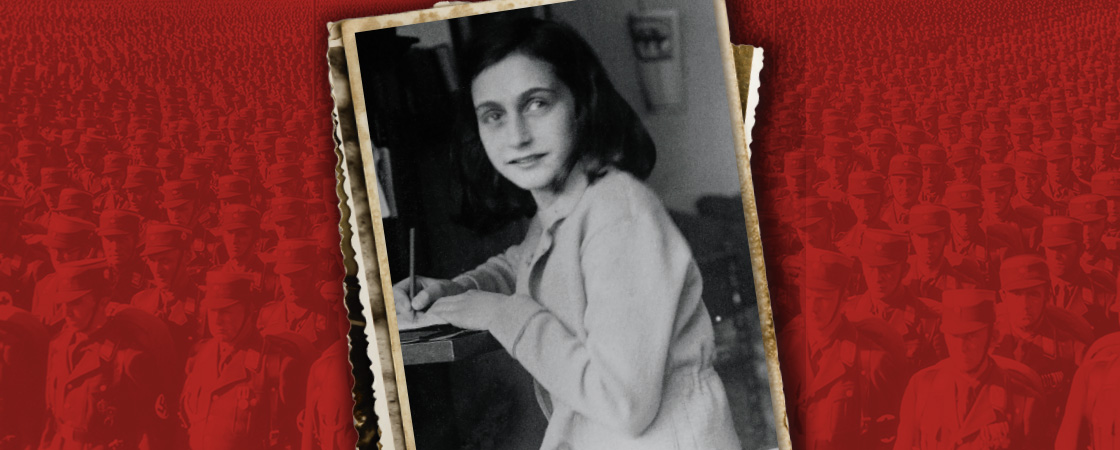 Black & white photo of Anne Frank writing at a desk