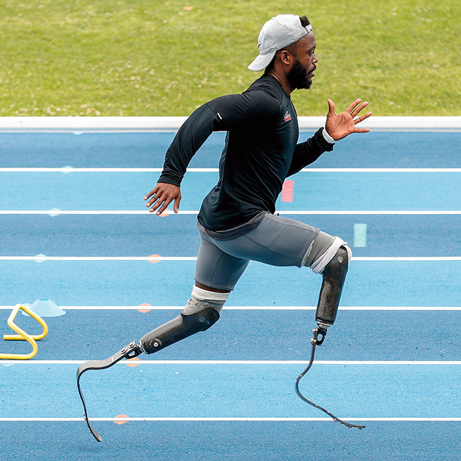 Photo of an athlete sprinting with two prosthetic legs