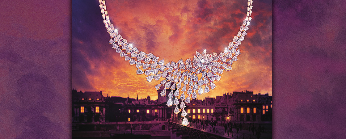 Image of a jewel necklace with a city in the background during sunset