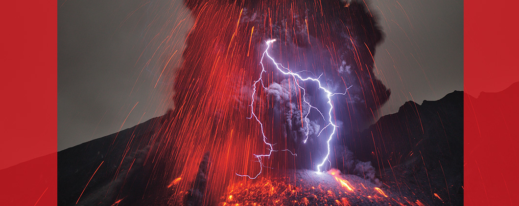 Image of lightning striking as red embers fall down through the air