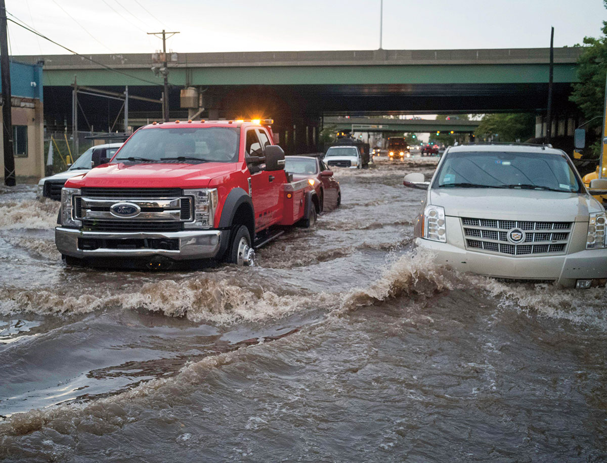 Cars driving through high flood waters